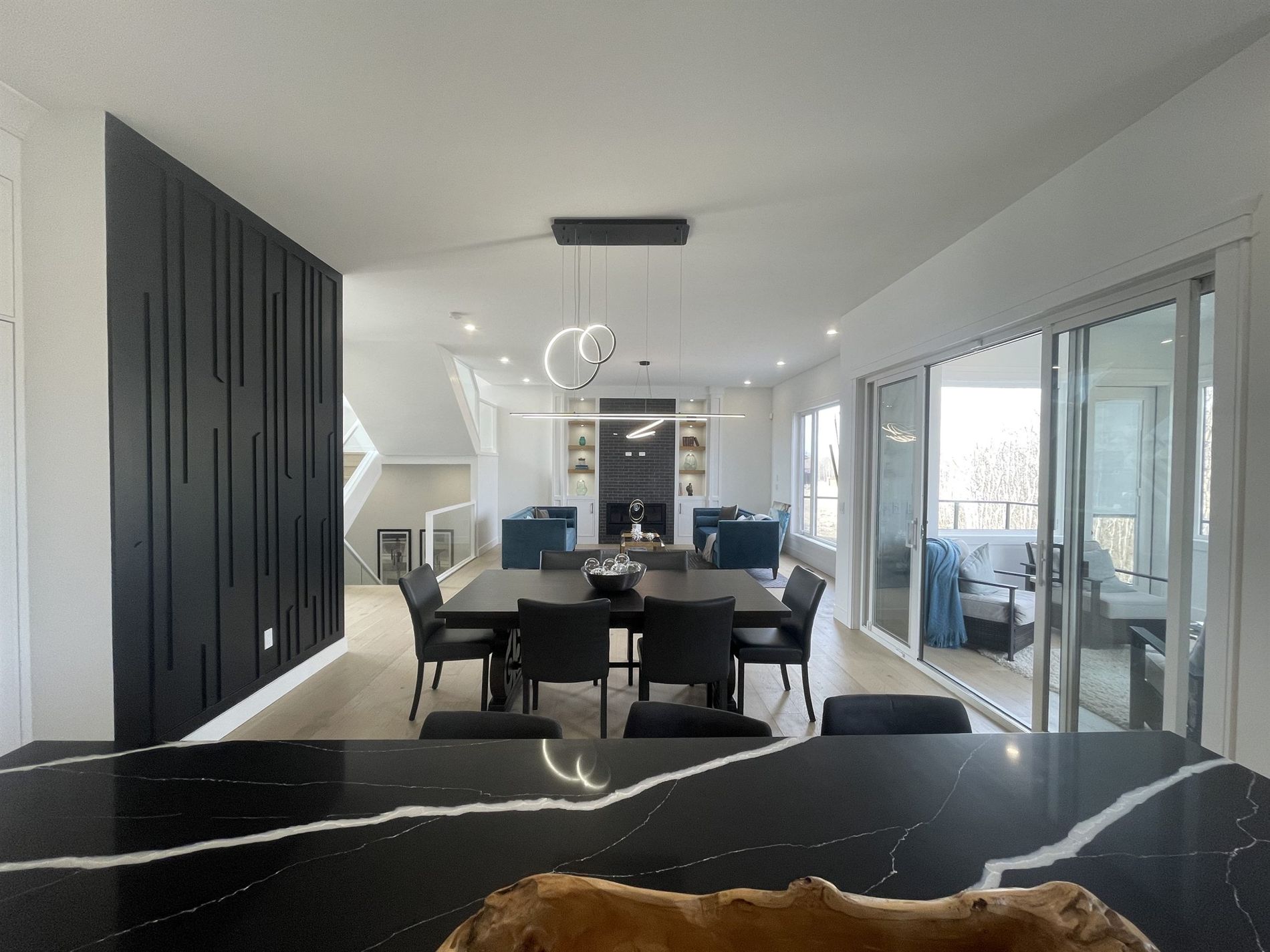 Great room with a vaulted ceiling, fireplace and sliding doors onto the deck