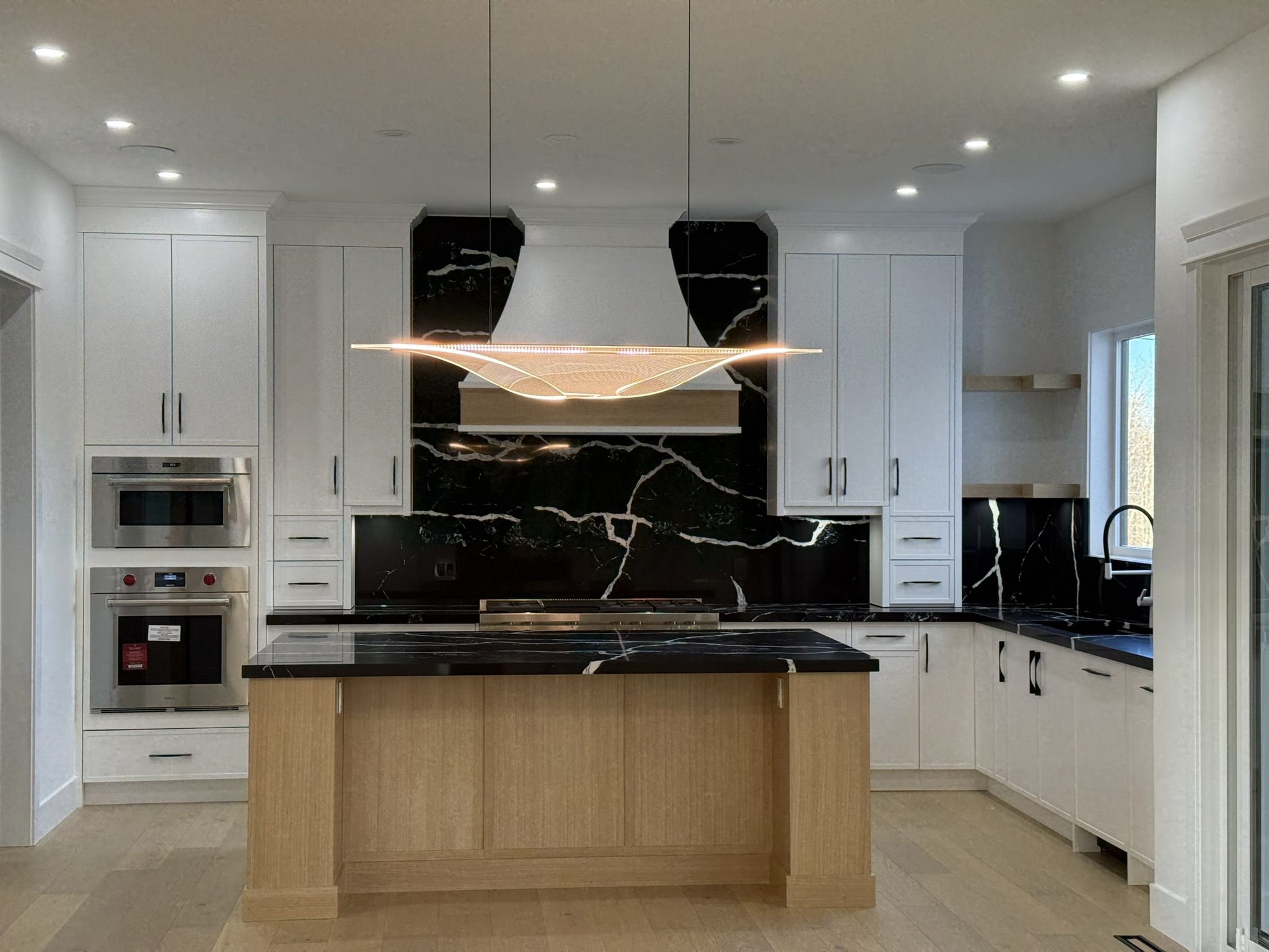 Kitchen with a black marble hood wall