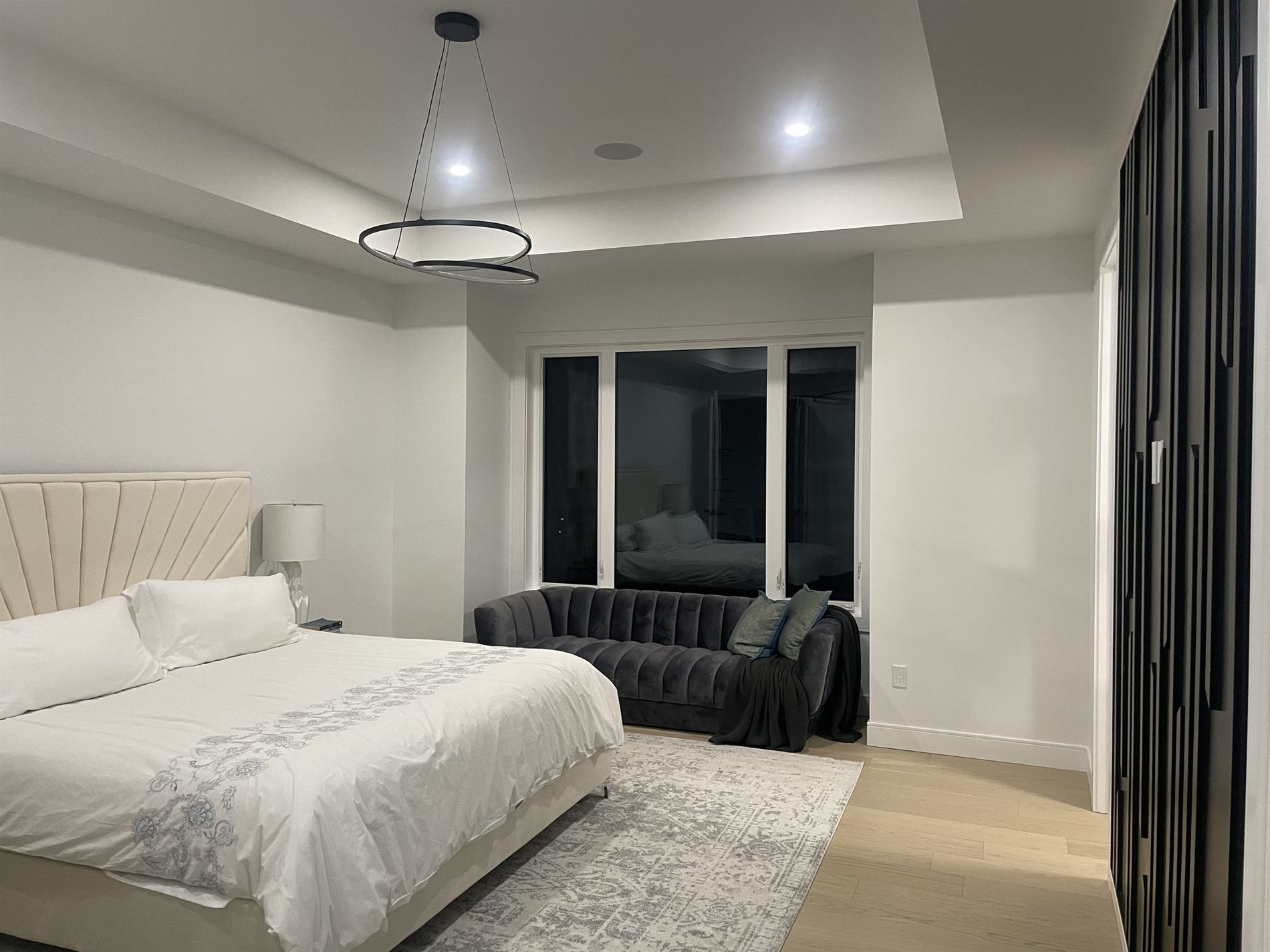 Primary bedroom with a tufted headboard
