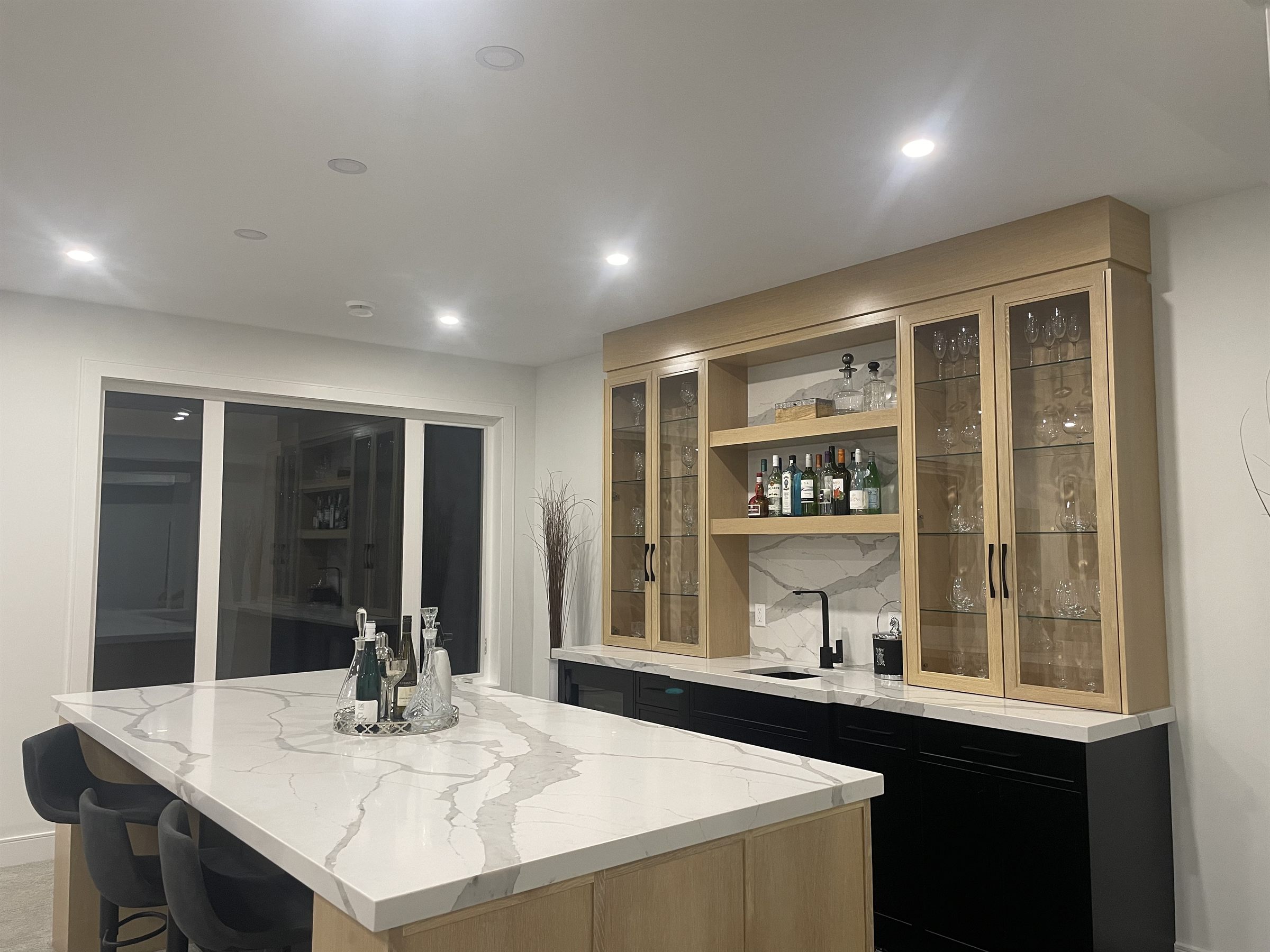 Wet bar with wine storage and glass-front cabinetry