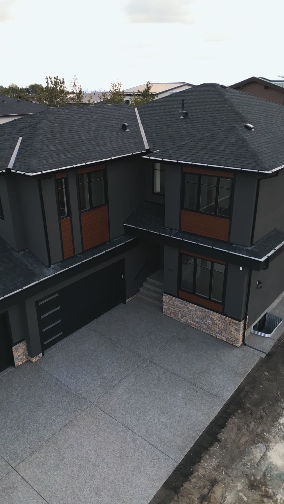 Aerial view of the front elevation and garage of a finished home